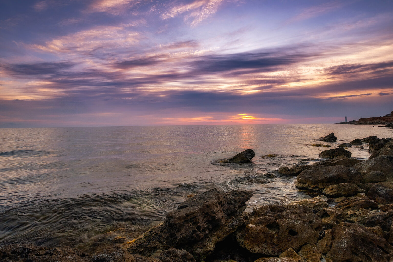 Dramatic Sunset Over Beach With A Natural Pond In The Foreground