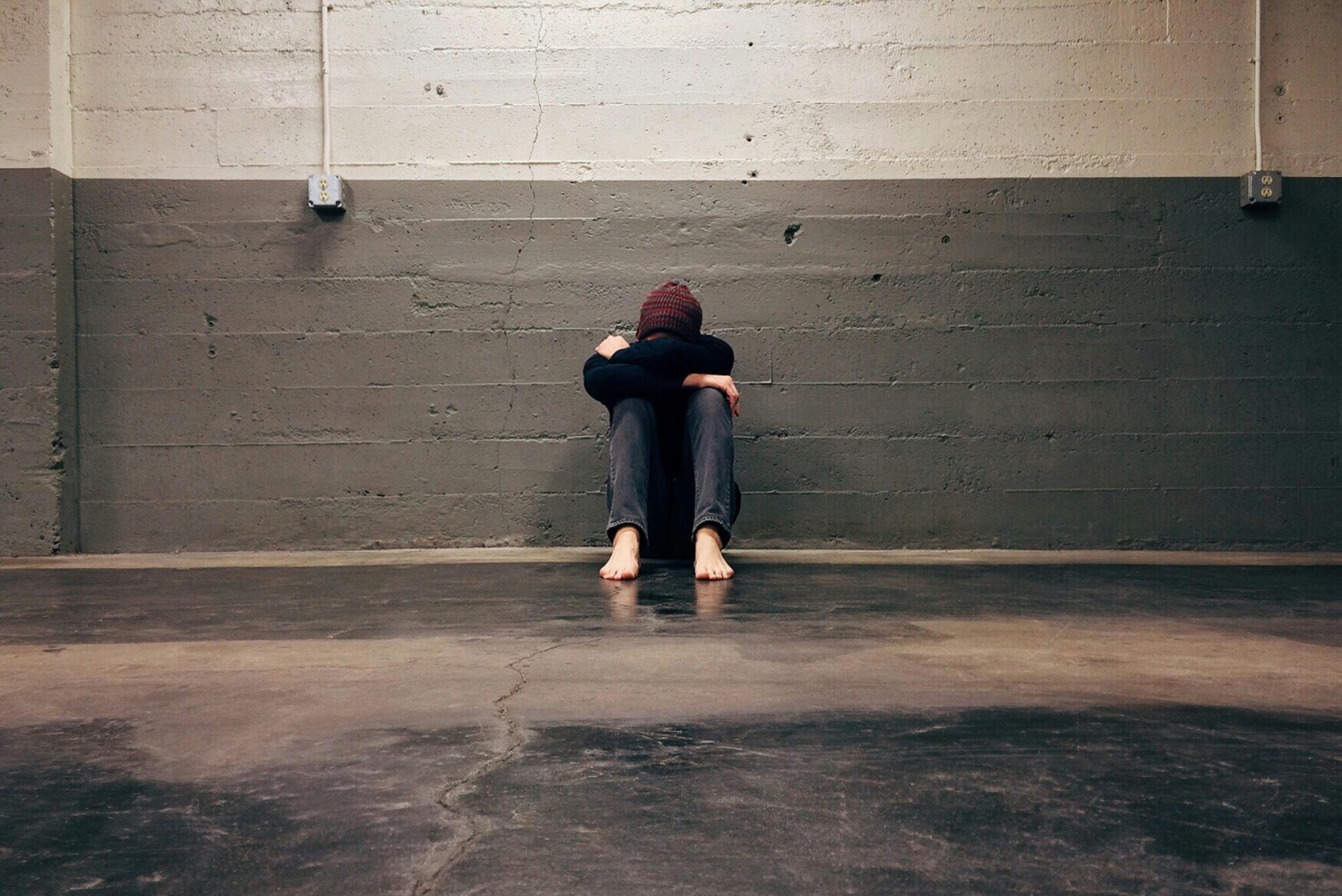 Sad person against wall